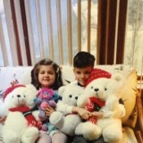 Two children holding stuffed animals